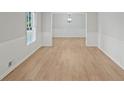 Bright living room with light wood floors and white wainscoting offers a clean, inviting space at 1260 White Oak Se St, Conyers, GA 30013