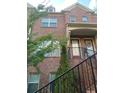 Lovely brick townhome with inviting front entrance, black railings, and well-placed windows at 1749 Breyerton Ne Dr, Atlanta, GA 30329