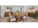 Elegant dining room with rustic wooden furniture and stylish striped chairs at 356 Lake Dr, Atlanta, GA 30354