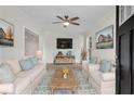 Bright living room featuring white sofas, a wood coffee table, and stylish decor at 356 Lake Dr, Atlanta, GA 30354