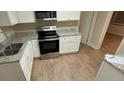 Bright kitchen featuring updated countertops, stainless steel oven and sleek white cabinetry at 2083 Meador Se Ave, Atlanta, GA 30315