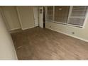 Living room with laminate wood flooring, white baseboards, and large bright windows at 2083 Meador Se Ave, Atlanta, GA 30315