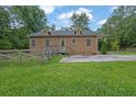 Back exterior of a single Gathering home with a well manicured lawn at 219 1St St, Woodstock, GA 30188