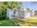 Inviting front entrance with a covered porch, white railings, and a well-manicured lawn at 7021 New Dale Rd, Rex, GA 30273