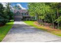 Charming two-story brick home featuring an attached two-car garage and mature landscaping at 3015 Guardian Nw Walk, Kennesaw, GA 30152