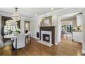 Bright dining room featuring a decorative fireplace, hardwood floors, and elegant chandelier at 502 Hascall Nw Rd, Atlanta, GA 30309