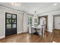 Cozy dining room with hardwood floors, a decorative mirror, and large windows for natural light at 502 Hascall Nw Rd, Atlanta, GA 30309