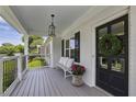 Inviting front porch featuring a bench, railing and a decorative wreath on the front door at 502 Hascall Nw Rd, Atlanta, GA 30309