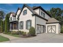 Lovely home featuring a painted brick facade, attached garage, and meticulously landscaped front yard at 2295 Abbey Cove Ct, Marietta, GA 30062