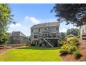 Expansive backyard featuring lush green grass, a wooden fence, a deck and stairs to the ground level at 428 Gold Xing, Canton, GA 30114