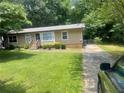 Home featuring manicured lawn, long paved driveway, and easy street access at 4434 Janice Dr, Snellville, GA 30039