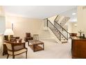 Comfortable living room featuring plush seating, neutral decor, and staircase leading to another level at 7098 Stonington Dr, Atlanta, GA 30328