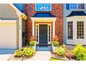 Close-up of the front door entrance, adorned with potted plants and a walkway leading to the welcoming entryway at 560 Edgehill Pl, Johns Creek, GA 30022