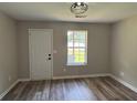 Bright, spacious bedroom featuring modern wood-look flooring and a rear access door at 6798 Blackstone Pl # 12, Mableton, GA 30126