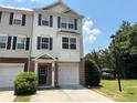 Charming townhome with a two-car garage, brick accents, and lush landscaping at 6798 Blackstone Pl # 12, Mableton, GA 30126