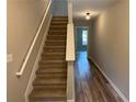 Inviting staircase with plush carpeting and a modern wood accent wall at 6798 Blackstone Pl # 12, Mableton, GA 30126