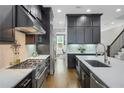 Open concept kitchen with stainless appliances, large island, and hardwood flooring at 328 Brownstones Cir, Atlanta, GA 30312