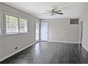 A bright living room with hardwood floors, a ceiling fan, and multiple windows offering natural light at 510 Se Boyds Se Dr, Marietta, GA 30067
