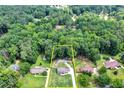 Aerial view of a wooded lot featuring a lovely home and well-maintained yard at 175 Hunters Gln, Fayetteville, GA 30215
