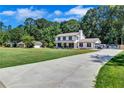 Beautiful two-story home featuring a long driveway, well-kept lawn, and inviting front porch at 175 Hunters Gln, Fayetteville, GA 30215