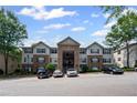 Exterior shot of the apartment building, showing the parking lot and some parked cars at 3303 Par Three Way, Lithonia, GA 30038