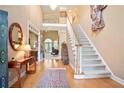 Grand foyer with hardwood floors, a staircase, and an open view to the living area at 3812 Mine Creek Ln, Marietta, GA 30062