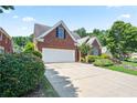Beautiful brick home showcasing well-maintained landscaping and a spacious driveway at 3812 Mine Creek Ln, Marietta, GA 30062