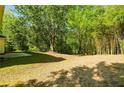 Expansive wooded backyard with mature trees offering plenty of privacy and natural beauty at 3554 Cherry Bloom Way, Decatur, GA 30034