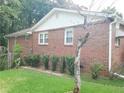 Brick home's side exterior featuring mature landscaping and maintained lawn at 3769 Amber Nw Rd, Atlanta, GA 30331
