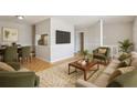 Cozy living room with hardwood floors, neutral paint, and ample natural light. adjacent to dining area at 4954 Browns Mill Rd, Lithonia, GA 30038