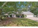 Inviting single-story home with a well-manicured lawn and mature shade trees adding curb appeal at 600 Cowan Rd, Covington, GA 30016