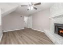 Cozy living room features wood floors and a stone fireplace at 100 Spicewood Ct, South Fulton, GA 30349
