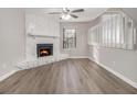 Cozy living room features wood floors and a stone fireplace at 100 Spicewood Ct, South Fulton, GA 30349
