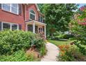 Inviting red brick home featuring lush landscaping, a charming walkway, and a welcoming front porch at 505 Armor Knl, Powder Springs, GA 30127