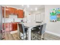 Well-lit kitchen has stainless appliances, granite counters, and island with seating at 840 United Se Ave # 205, Atlanta, GA 30312