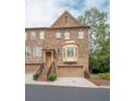 Elegant multi-story townhome featuring a brick facade, bay window, and a convenient attached garage at 2567 Willow Field Se Xing # 22, Marietta, GA 30067
