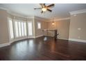 Large living room with hardwood floors, fireplace, crown molding and a staircase to the second floor at 2567 Willow Field Se Xing # 22, Marietta, GA 30067