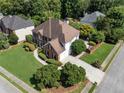 Aerial view showcasing the home's well-maintained lawn, two-car garage, and lush surroundings at 2956 Nestle Creek Dr, Marietta, GA 30062