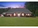 Beautiful red brick home features a spacious front yard, manicured lawn, and classic architectural details at 2631 Young Rd, Stone Mountain, GA 30088
