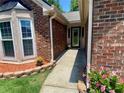 The front entrance is adorned with brick trim and an ornate glass door at 5022 Anclote Dr, Alpharetta, GA 30022