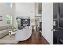 Grand foyer with soaring ceilings, hardwood floors, and a view into the elegant dining room at 5545 Adirondack Dr, Cumming, GA 30040