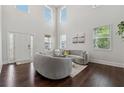 Bright and open living room with large windows, hardwood floors, and comfortable seating area at 5545 Adirondack Dr, Cumming, GA 30040