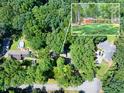 Aerial view of property showcasing its lush surroundings, pool, and proximity to other homes in the neighborhood at 686 Hillwood Ct, Dacula, GA 30019