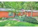 Charming home exterior with lush landscaping, mature trees, and inviting curb appeal at 686 Hillwood Ct, Dacula, GA 30019