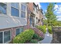 Charming brick townhome with manicured landscaping, inviting entrance and sunny curb appeal at 5504 Cameron Parc Dr, Alpharetta, GA 30022