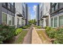 Charming brick pathway through a residential community with modern townhomes and lush greenery at 704 Banton Nw Dr, Atlanta, GA 30318