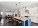 Open concept kitchen with large island, stainless steel appliances, and modern pendant lighting at 704 Banton Nw Dr, Atlanta, GA 30318