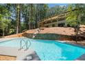 Gorgeous inground pool, cascading waterfall and wooded views at 9025 Huntcliff Trce, Atlanta, GA 30350