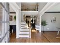 Spacious foyer with hardwood floors, staircase, and views into the dining and living areas at 998 Poplar Mill Ct, Buford, GA 30518