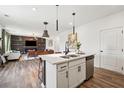 Modern kitchen with an island, stainless steel appliances, and stylish lighting at 1001 Starmoss Ln, Conyers, GA 30094